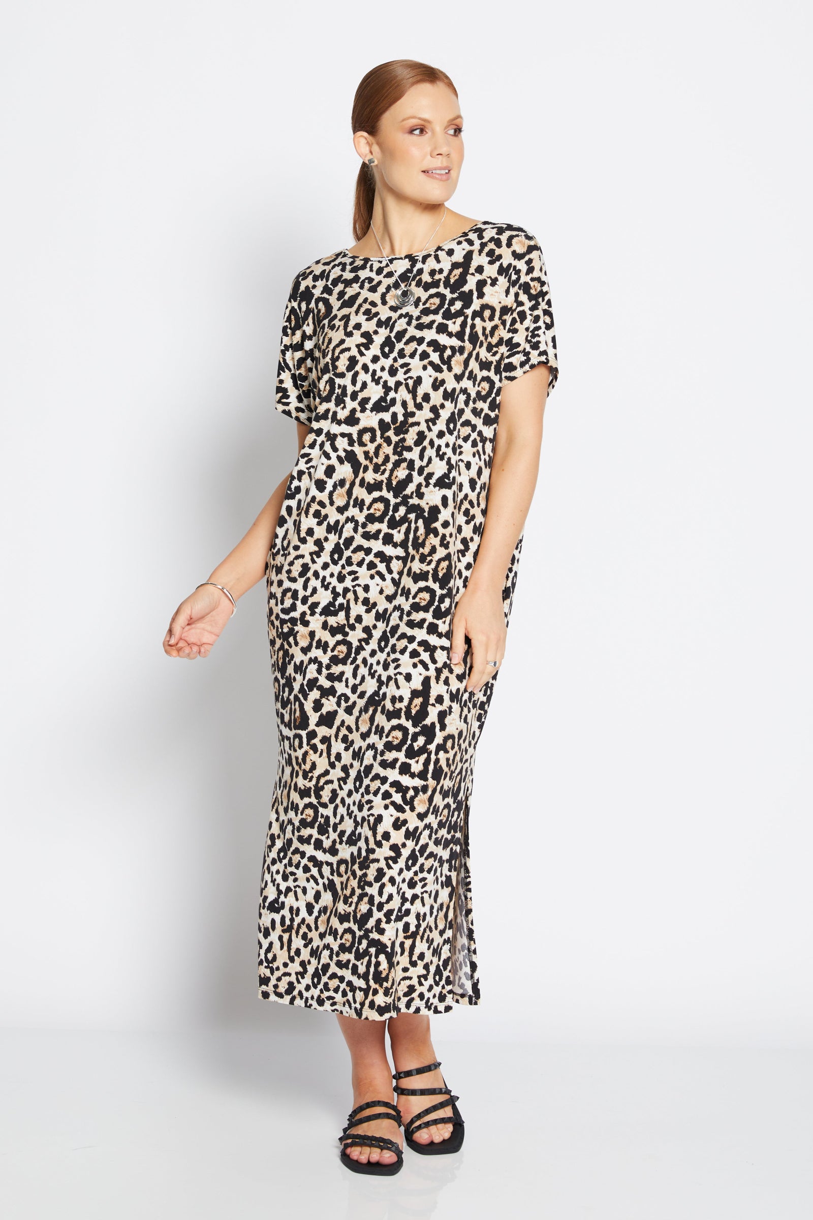 Woman wearing a leopard print dress on a white background