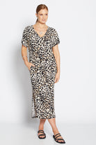 Woman wearing a leopard print dress on a white background