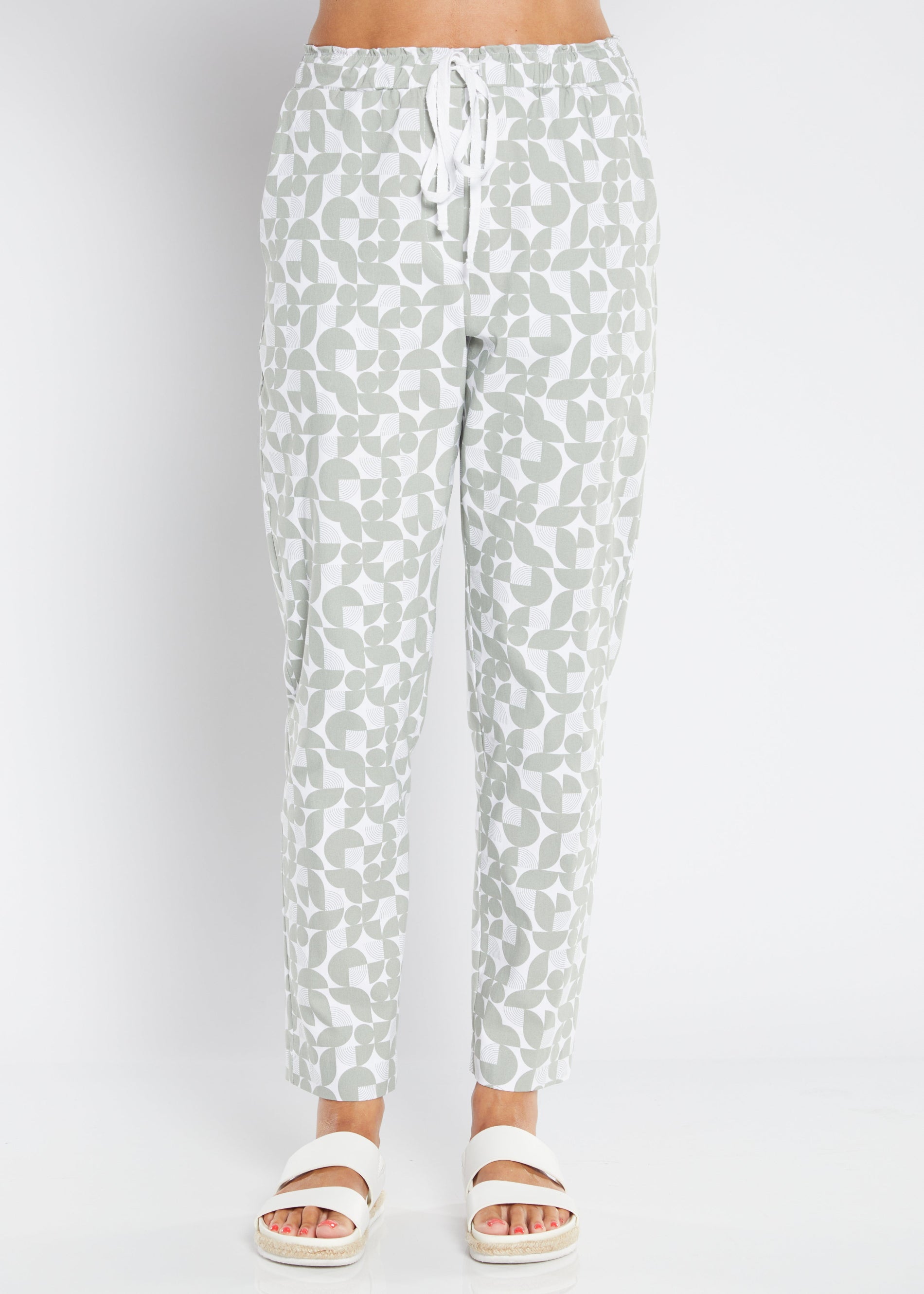 sage green and white pants on plain background