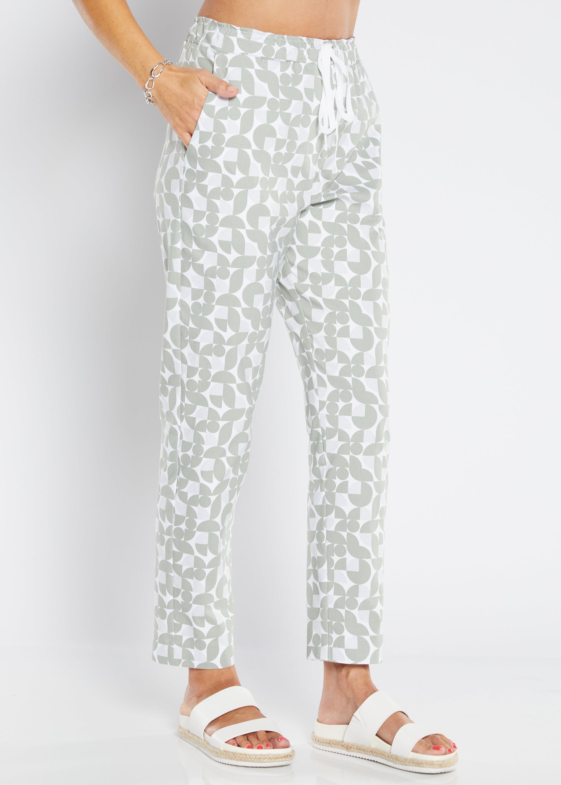 Person wearing light-colored pants with a subtle pattern on a white background