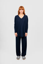 Person wearing a navy blue outfit on a white background