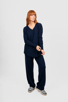 Person wearing a navy blue outfit on a white background