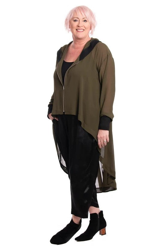 Woman wearing a long olive green cardigan over a black outfit on a white background