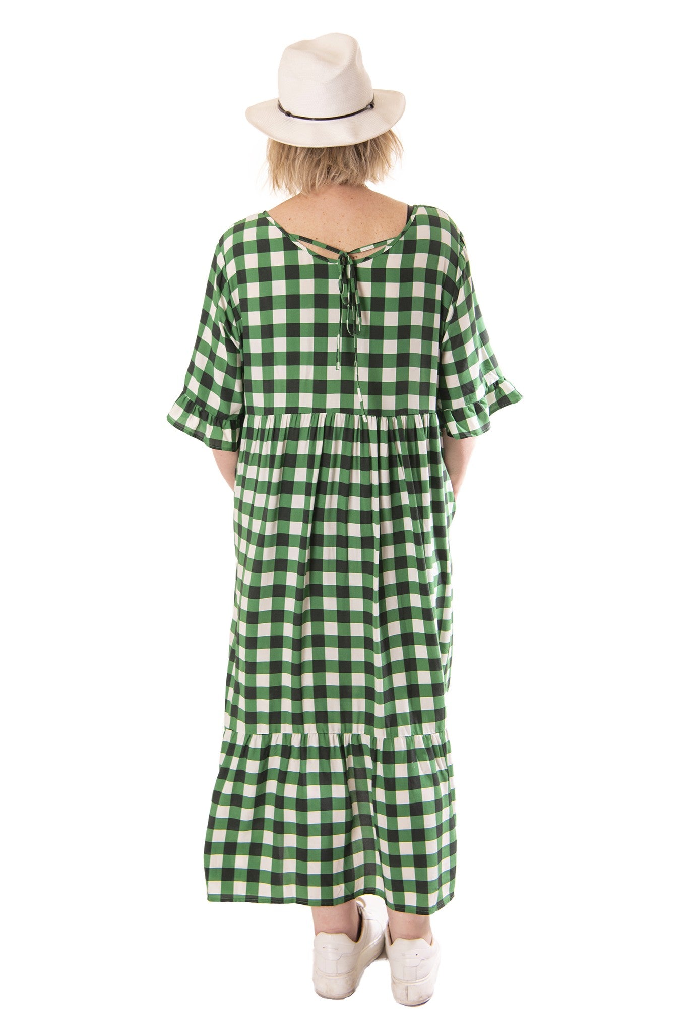 Green checkered dress worn by a person on a white background back view