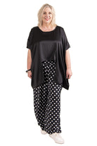 womens wide leg black white spot pant and black top worn by model 