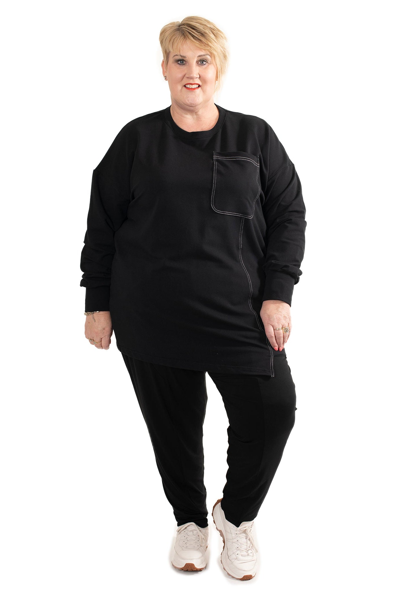 Person wearing a black outfit with a pocket on a white background