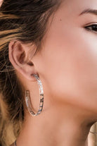 silver gold hoop earrings with map and clock detail on ear