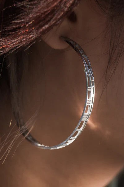 silver gold hoop earrings with map and clock detail on ear