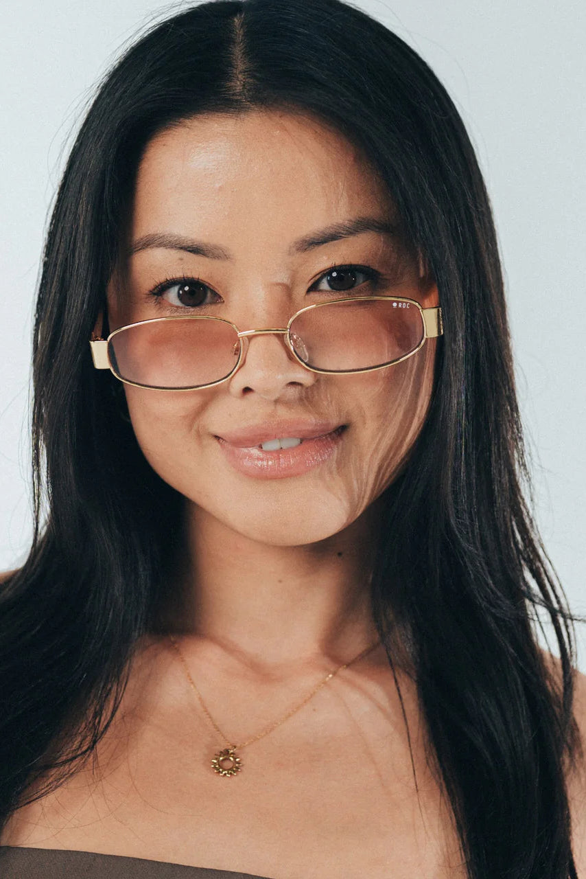 Woman wearing glasses with a neutral background