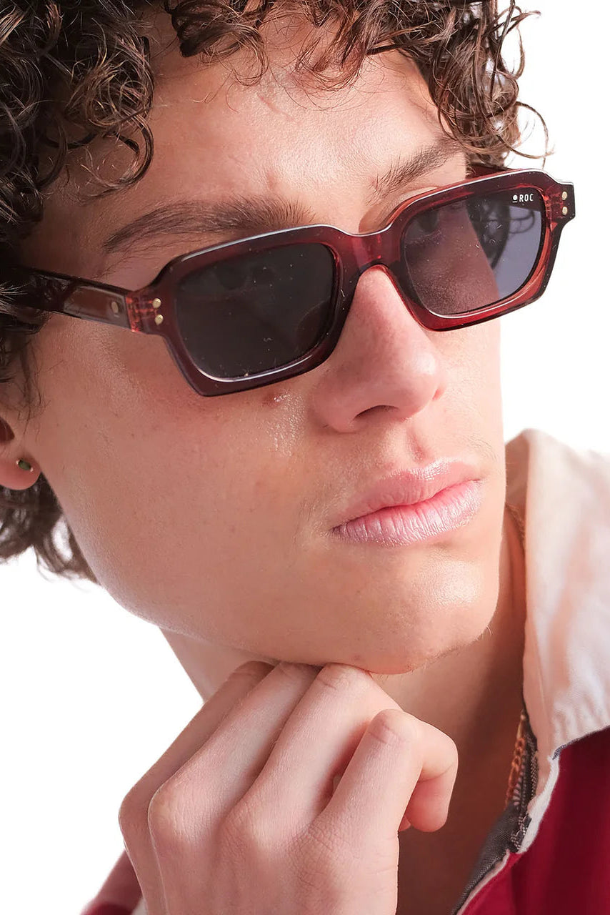 Person wearing sunglasses with a neutral background