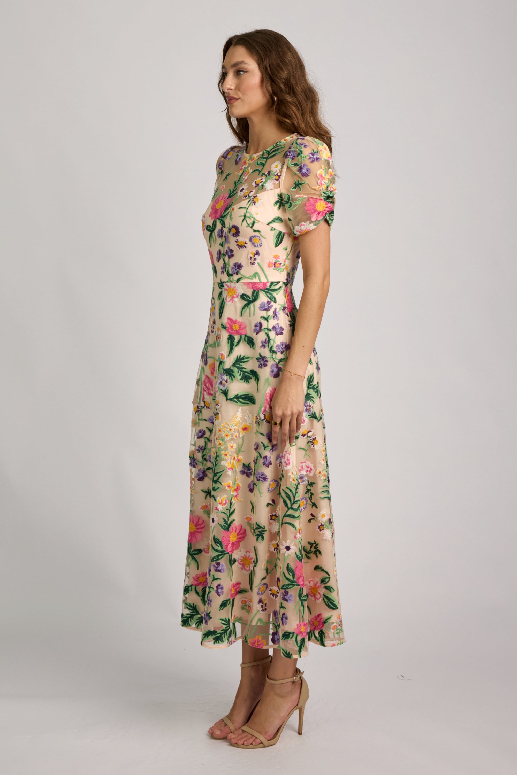 Woman wearing a floral dress on a plain background