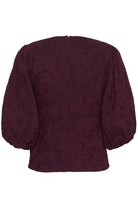 Maroon textured blouse on a white background