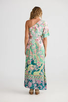 Woman wearing a one-shoulder floral dress on a white background back