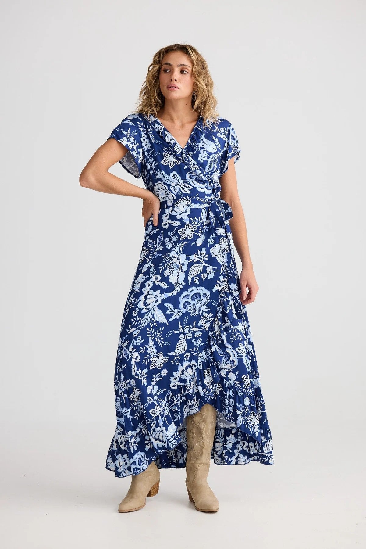 Woman wearing a blue floral dress on a white background