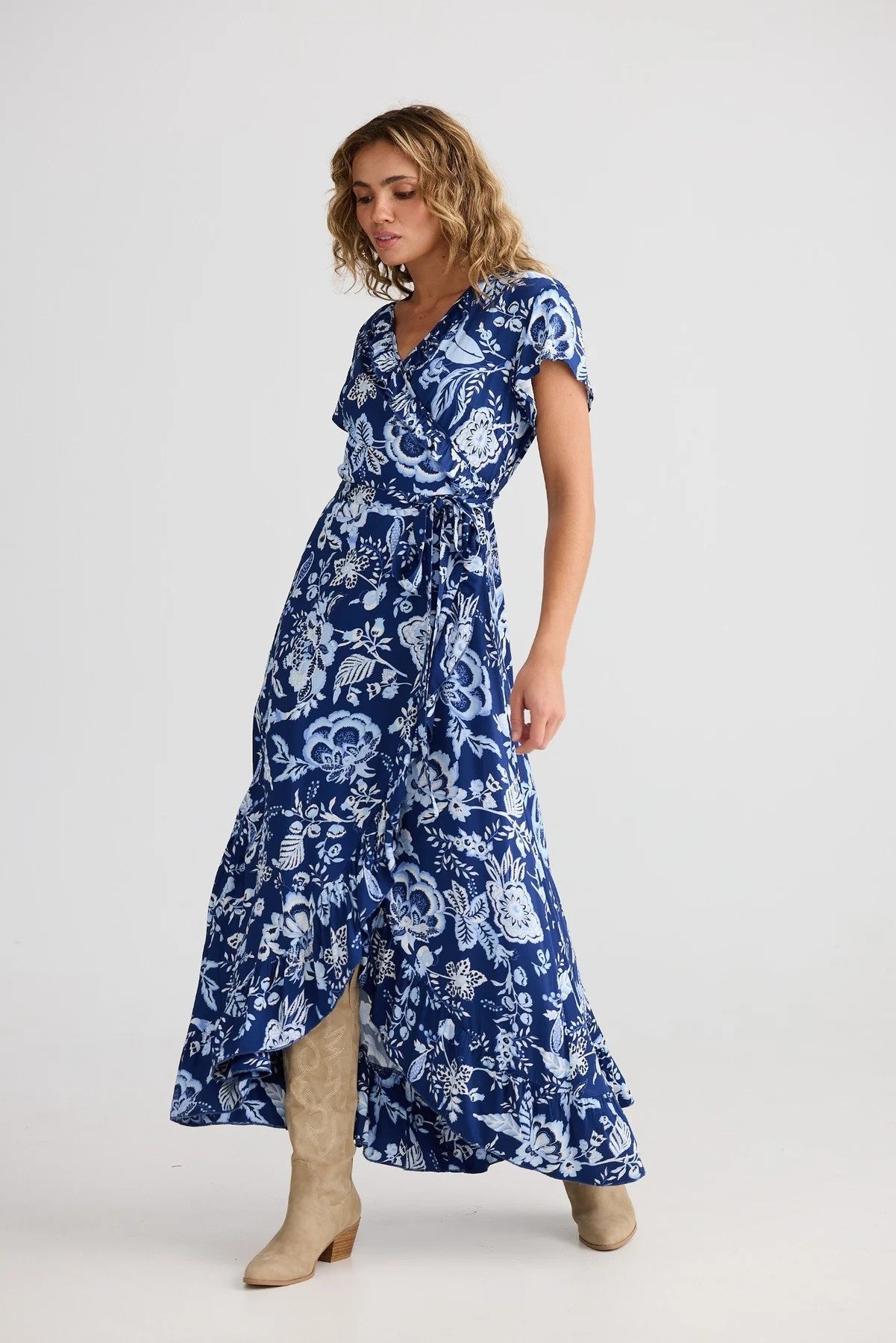Woman wearing a blue floral dress on a white background