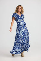 Woman wearing a blue floral dress on a white background