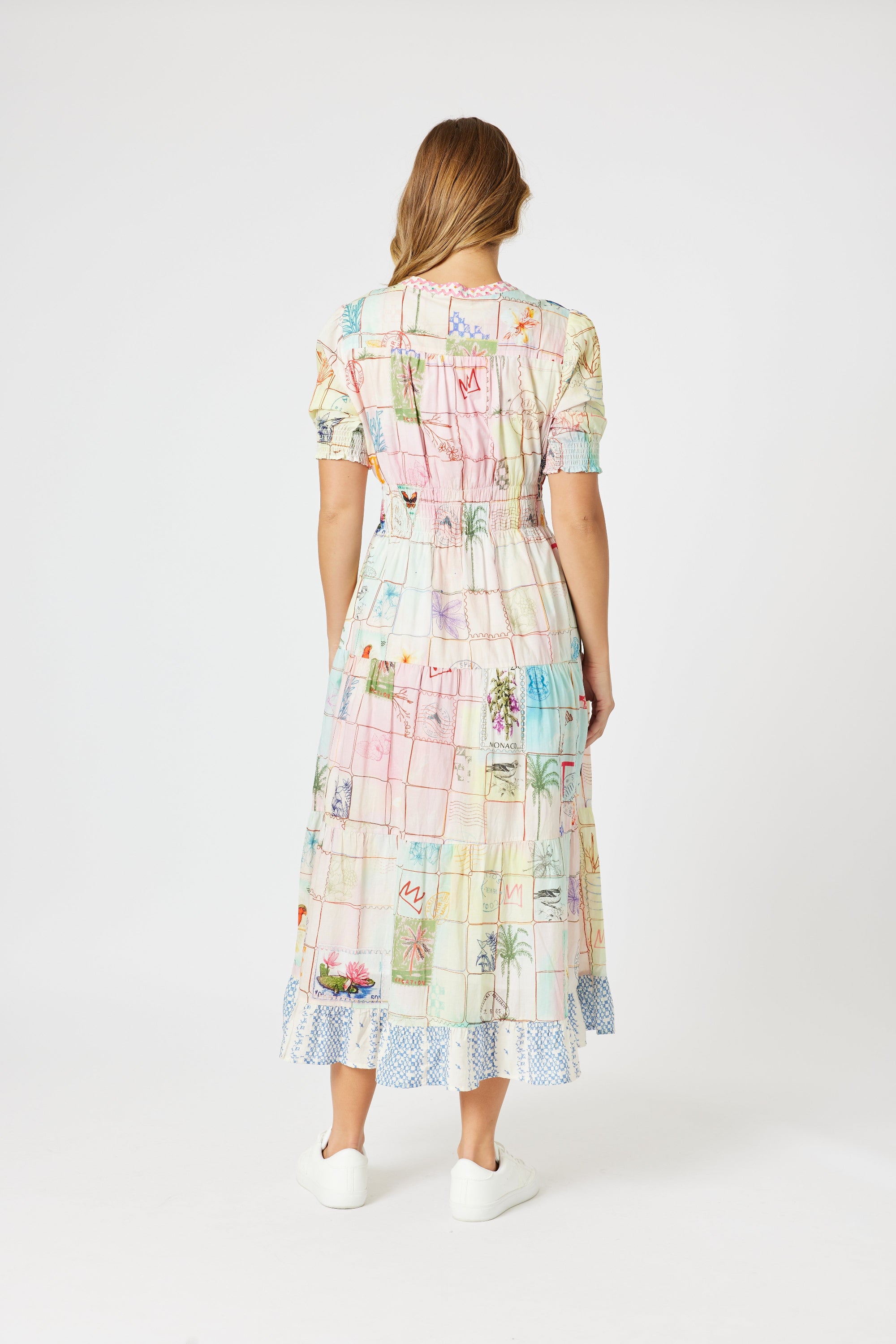 model wering pastel multi print maxi dress against white background