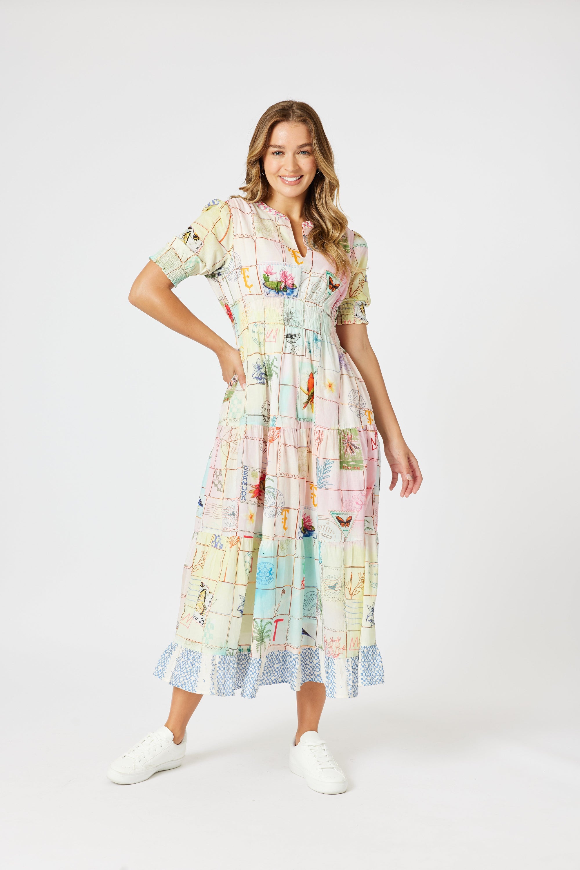 model wering pastel multi print maxi dress against white background
