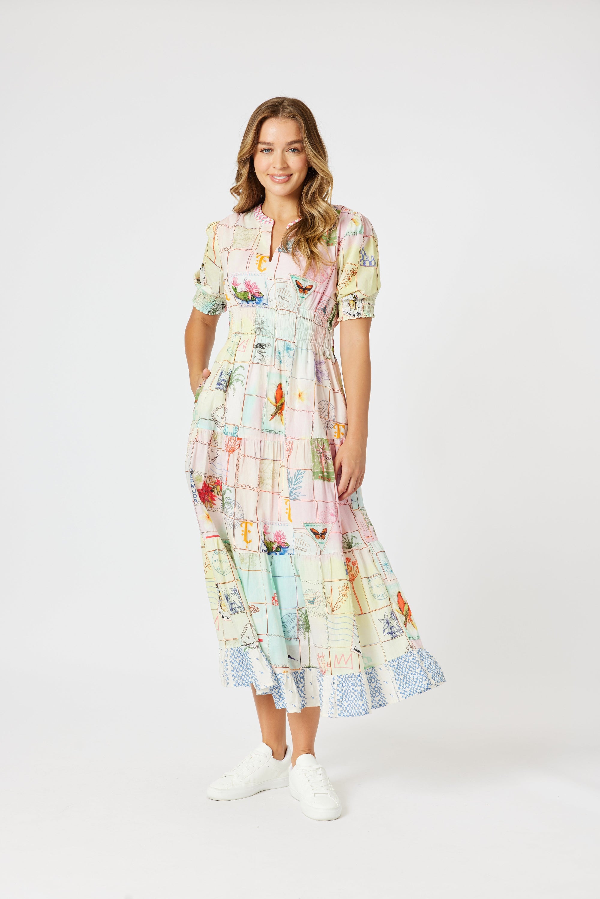 model wering pastel multi print maxi dress against white background