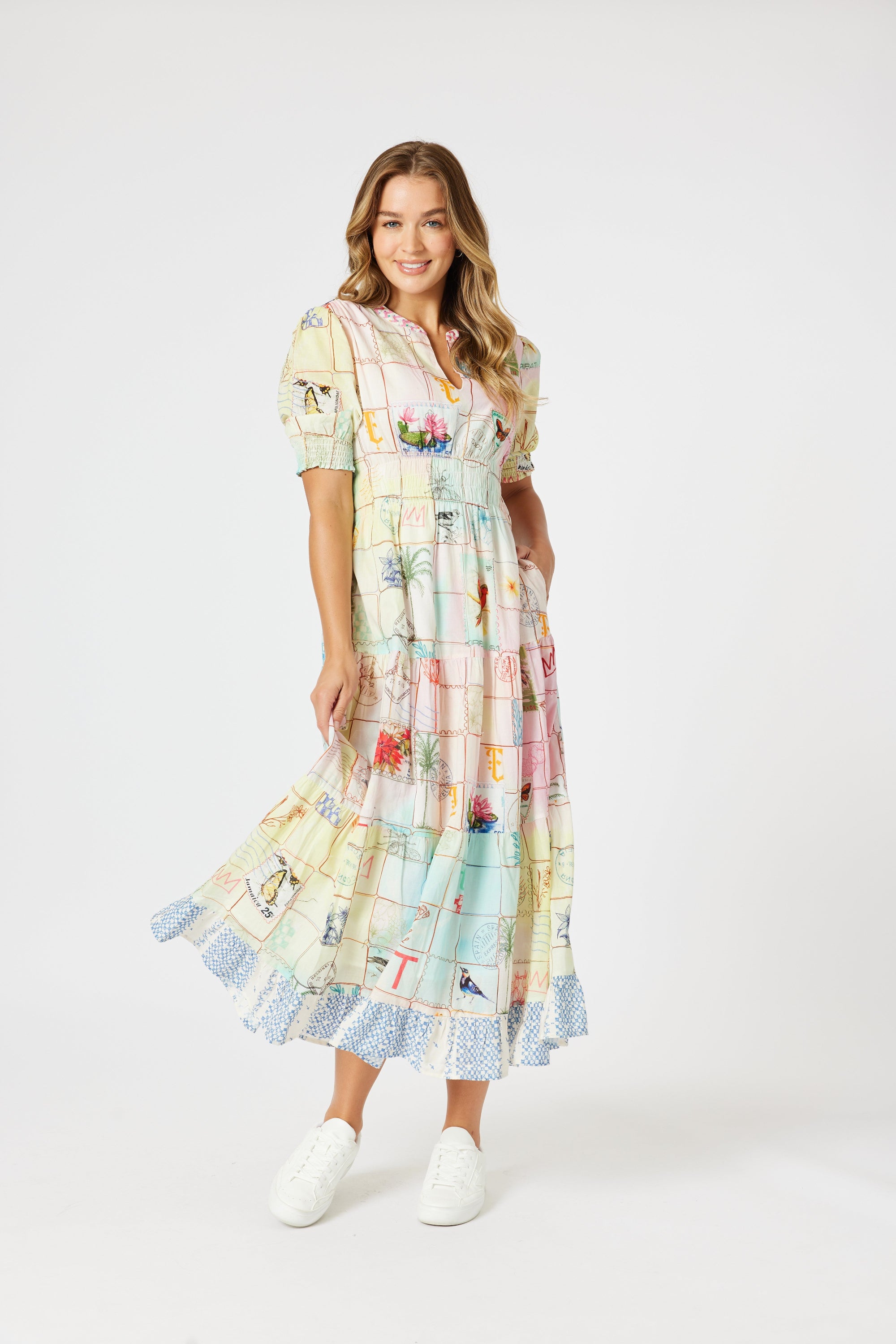 model wering pastel multi print maxi dress against white background