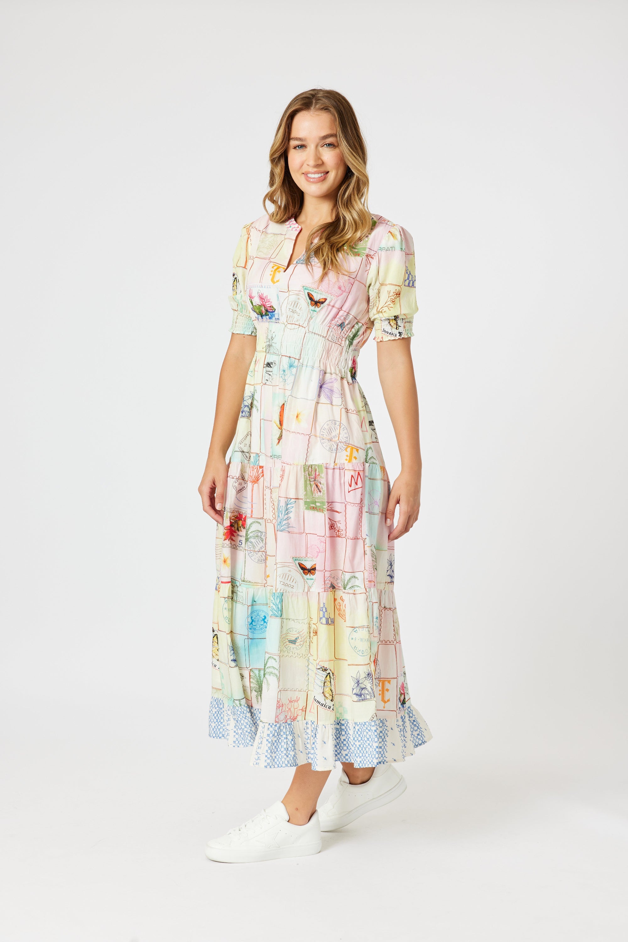 model wering pastel multi print maxi dress against white background
