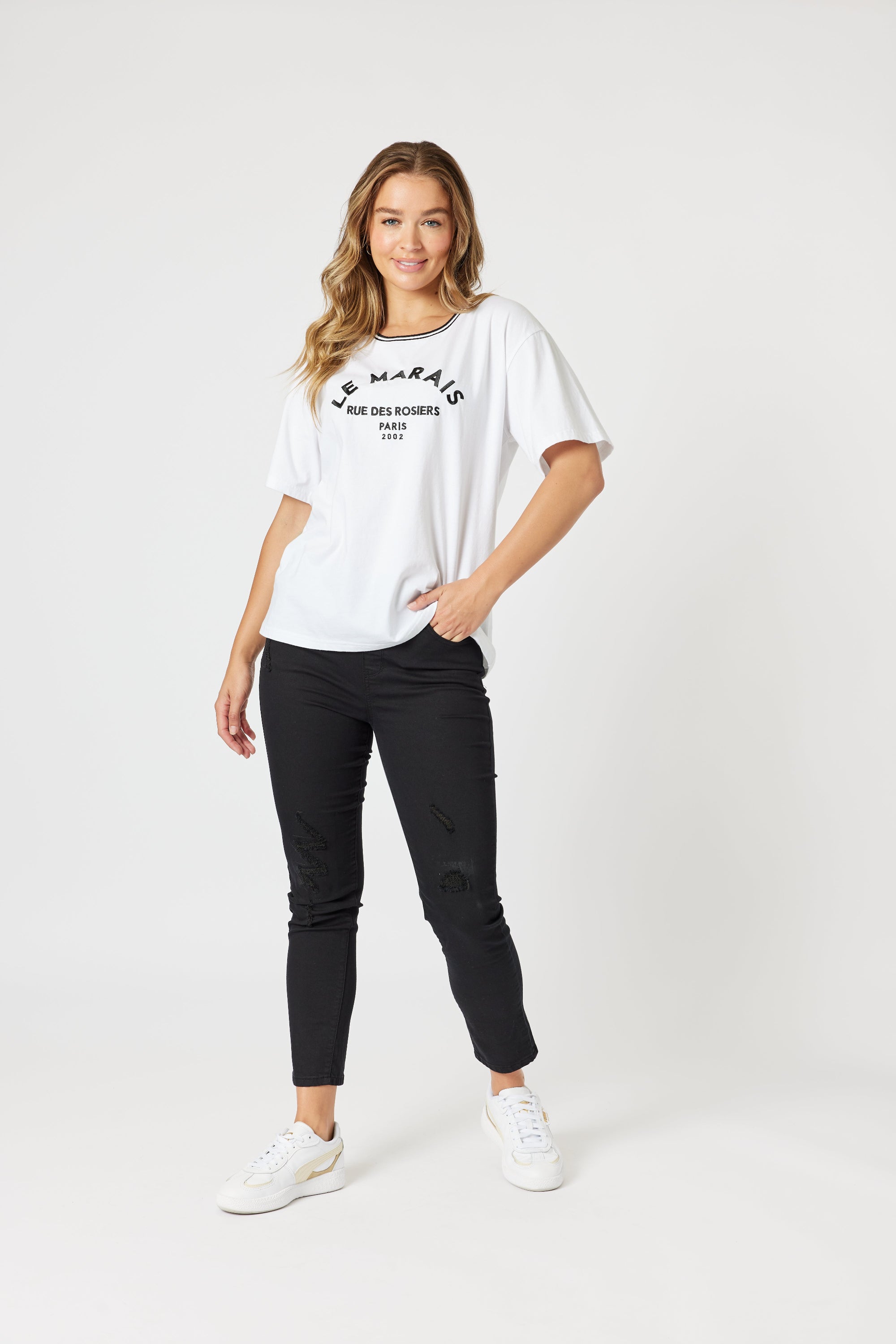 womens boxy white tee with embroidered le marais print worn by model 