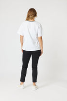 womens boxy white tee with embroidered le marais print worn by model back view