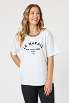 womens boxy white tee with embroidered le marais print worn by model 