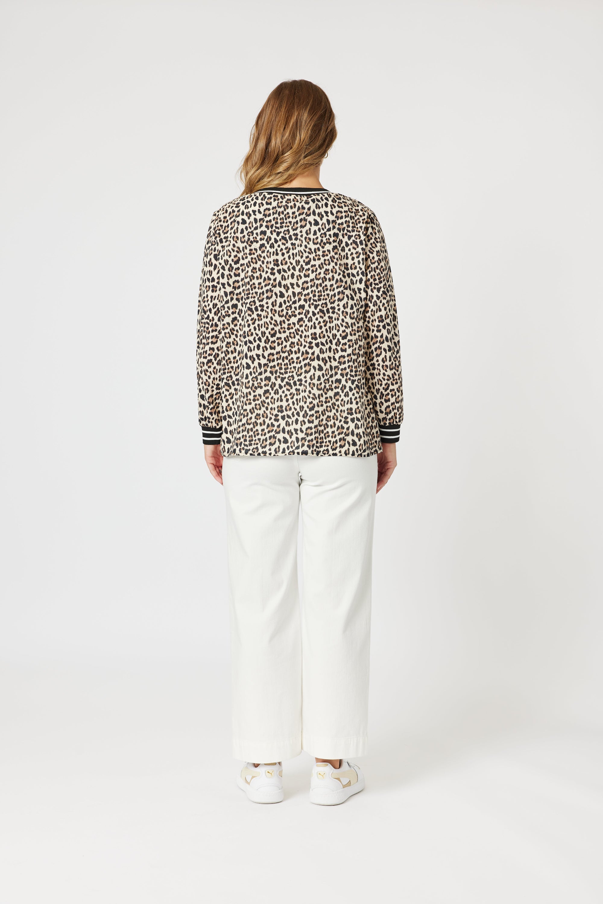 womens v neck leopard print top with black white contrast trims worn my model back view