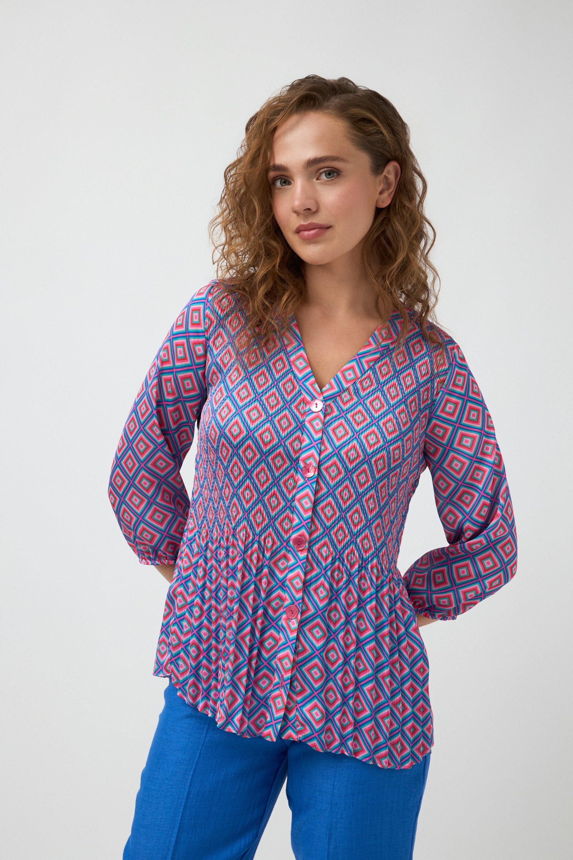geometric print blouse in pink and blue worn by model 