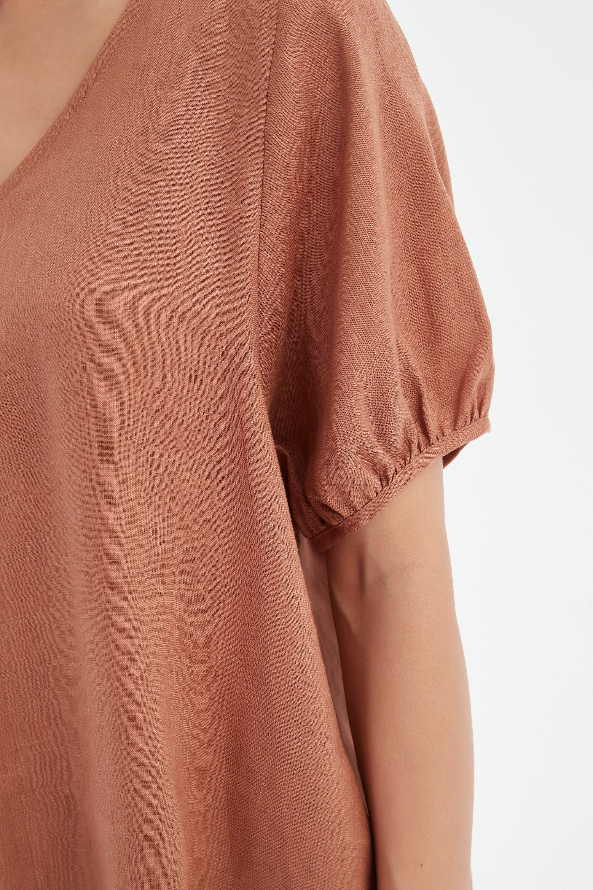 bishop sleeve v neck top in brown cedar worn by model close up