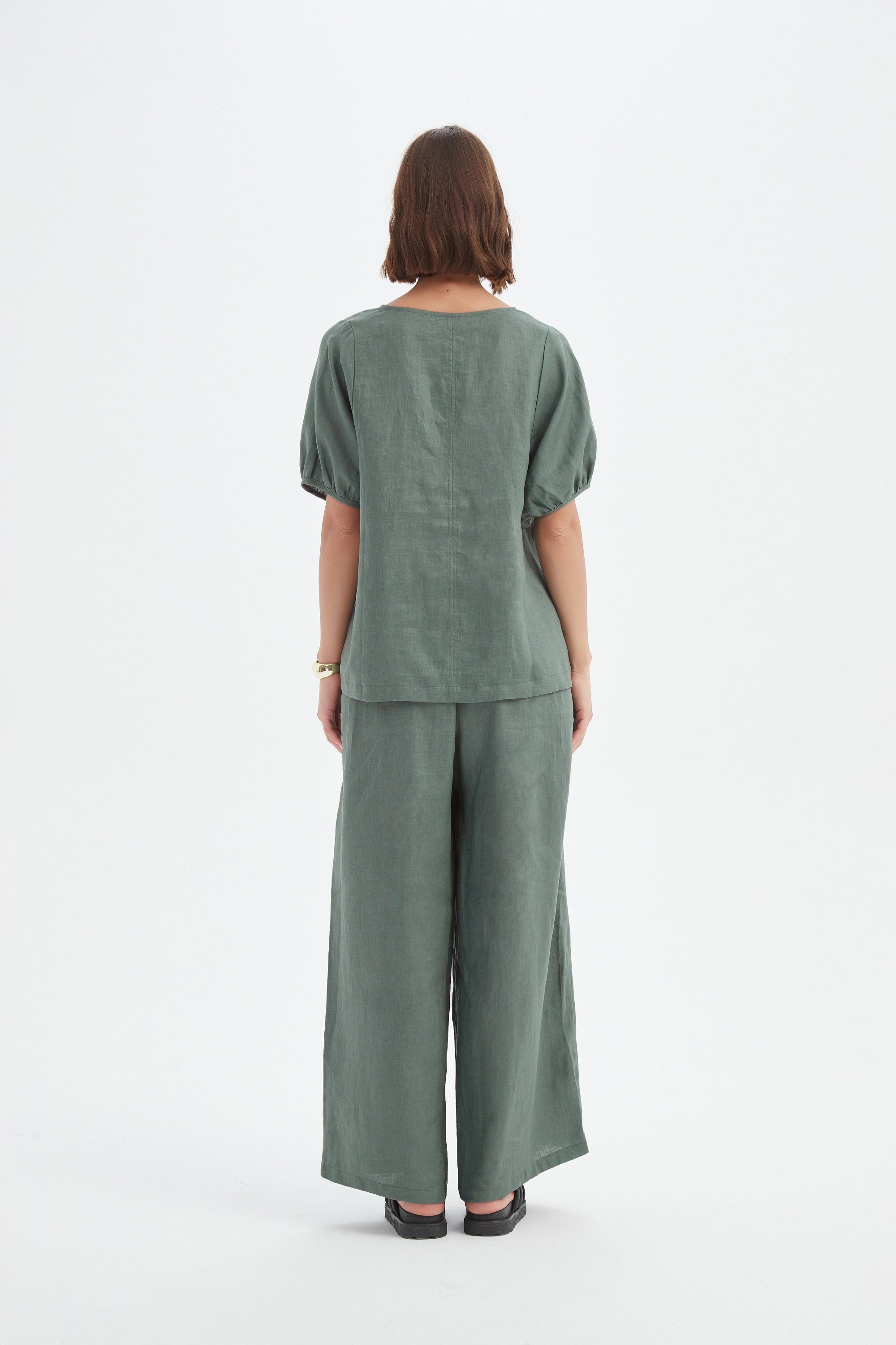 bishop sleeve v neck top in petrol worn by model back view