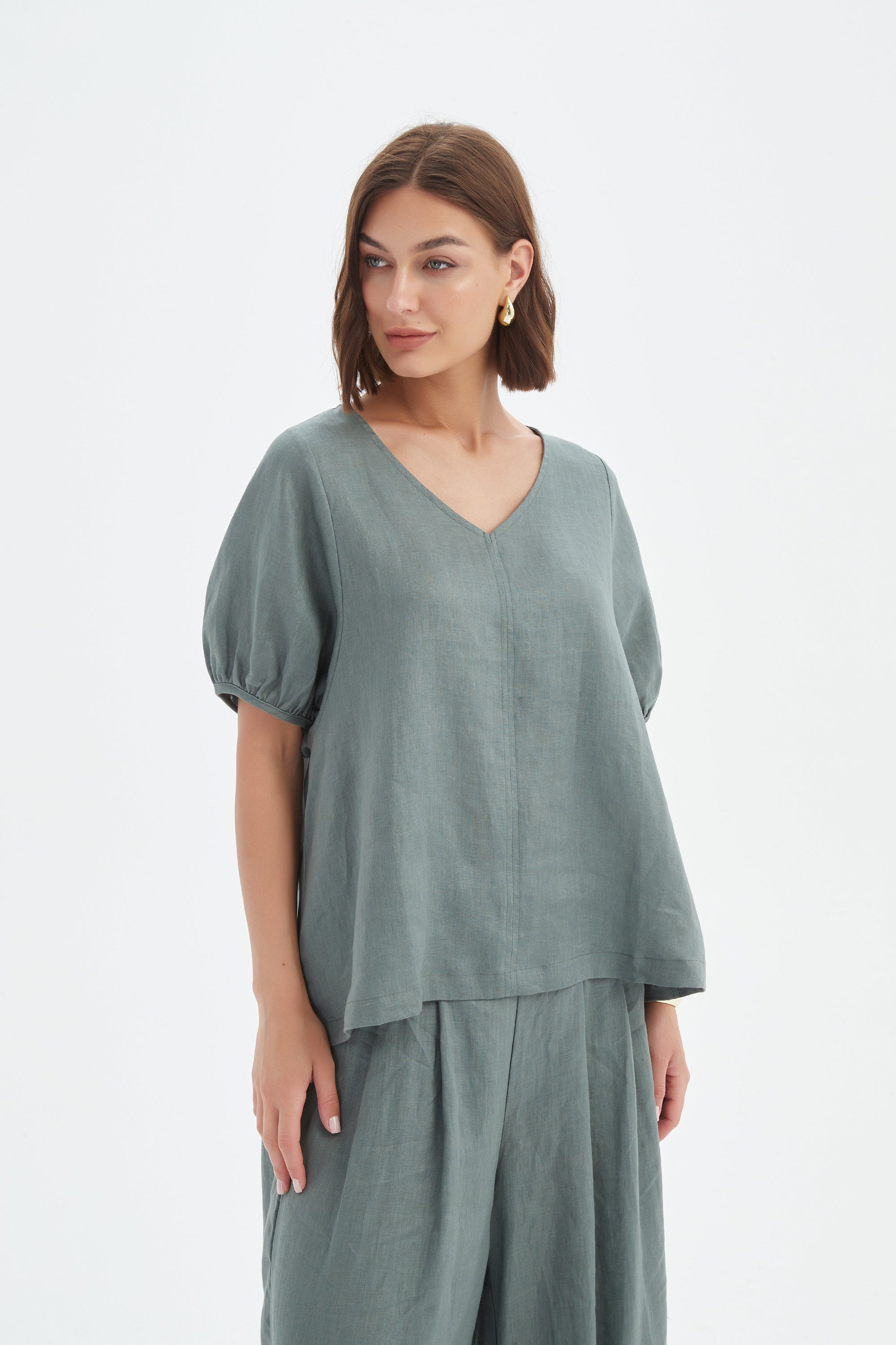 bishop sleeve v neck top in petrol worn by model 