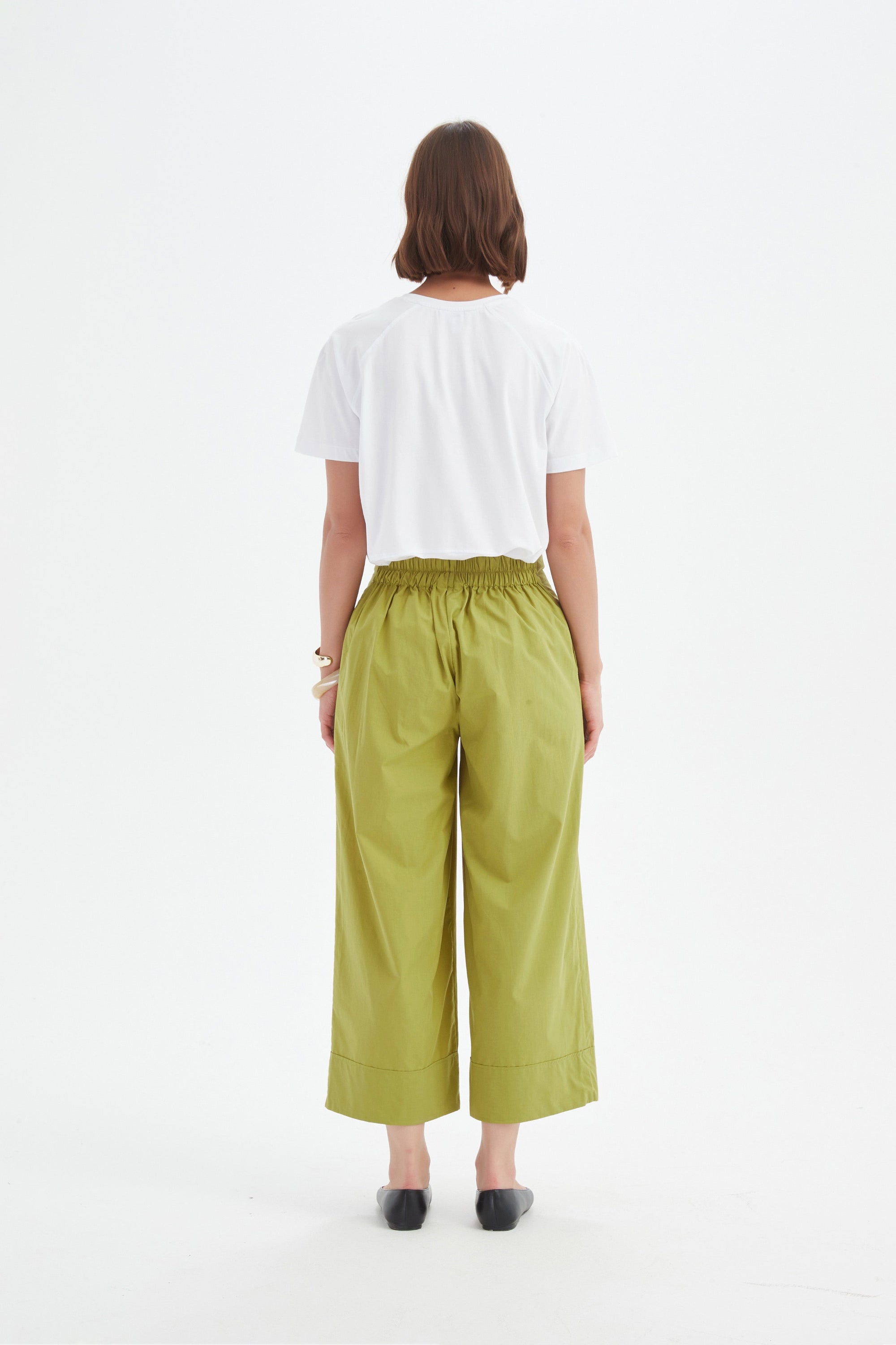 pea green wide leg pant and white tee worn by model back