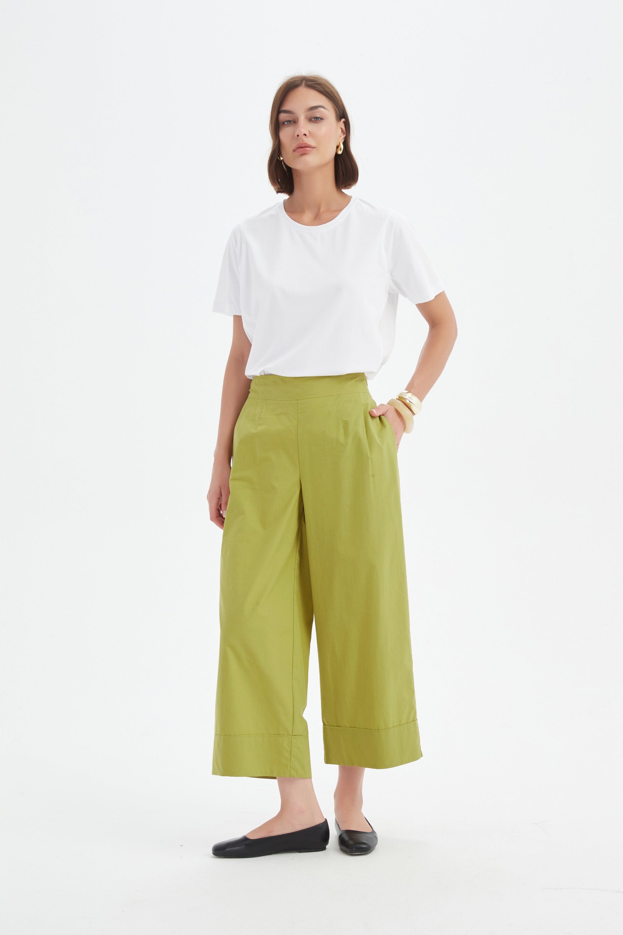 pea green wide leg pant and white tee worn by model 