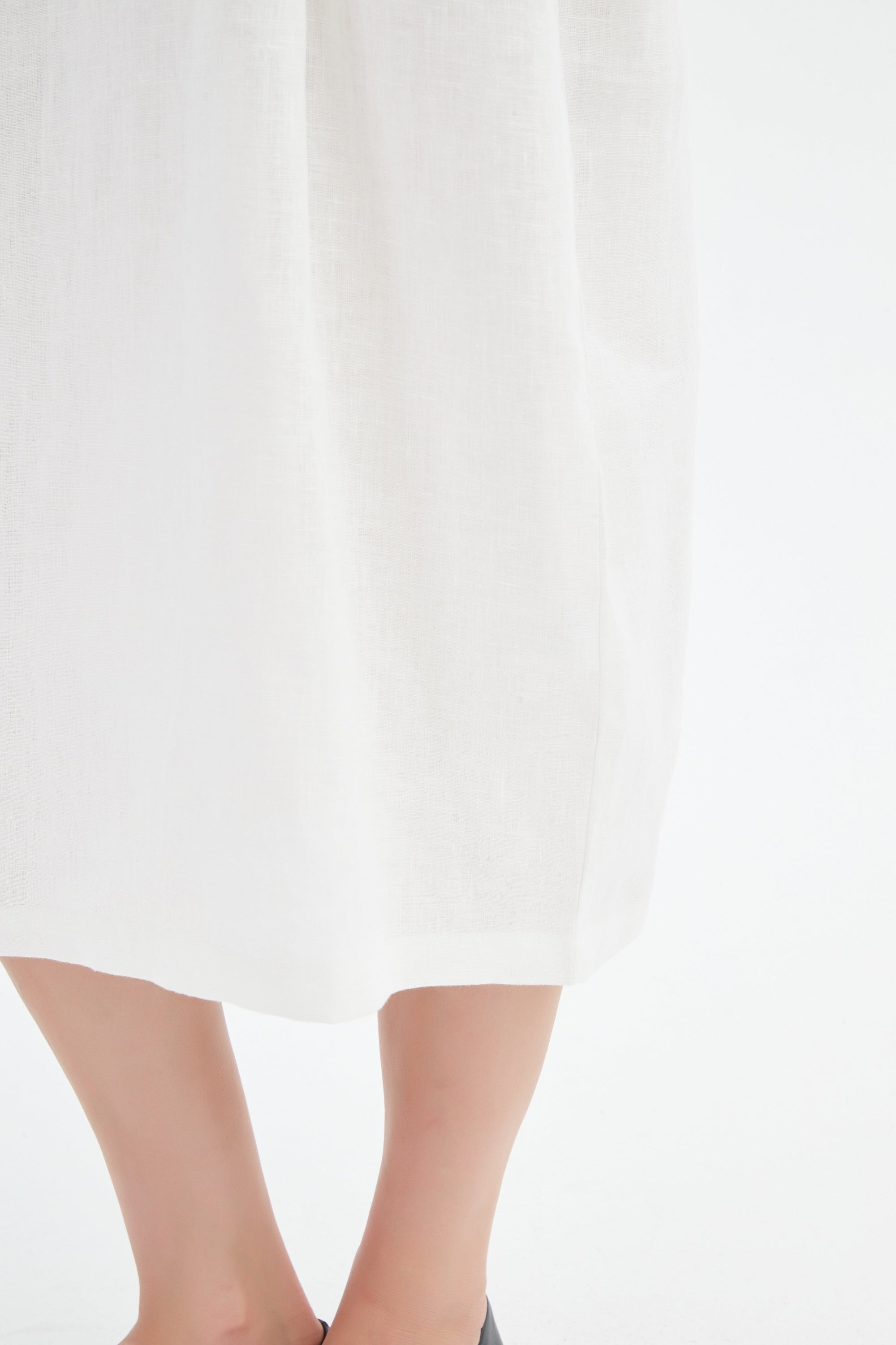 cream midi dress with black contrast worn by model detail