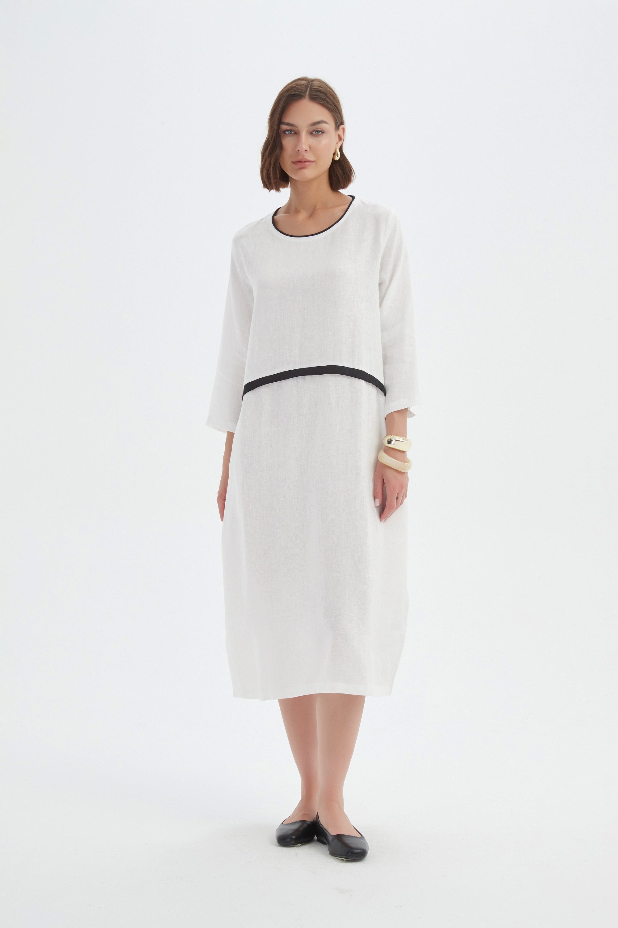 cream midi dress with black contrast worn by model 