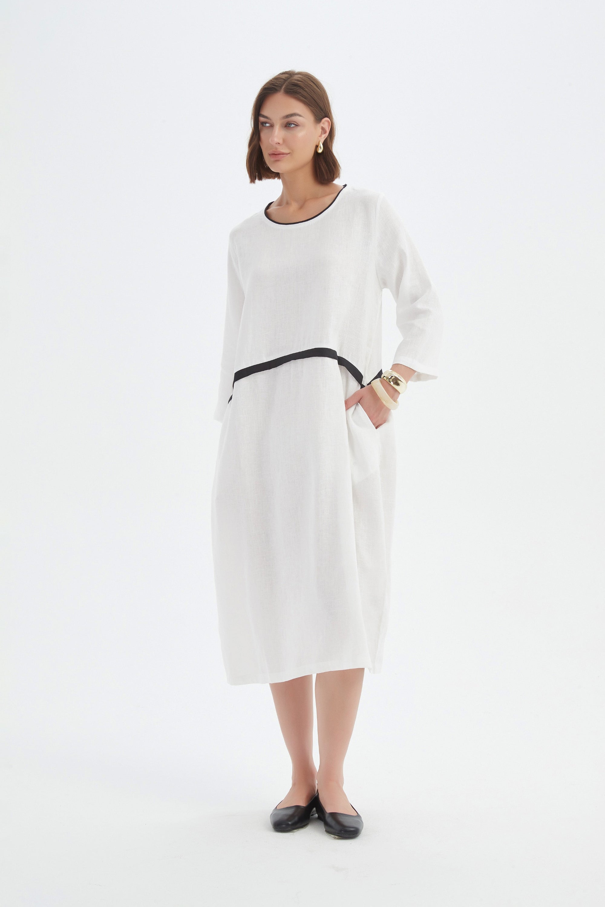 cream midi dress with black contrast worn by model 