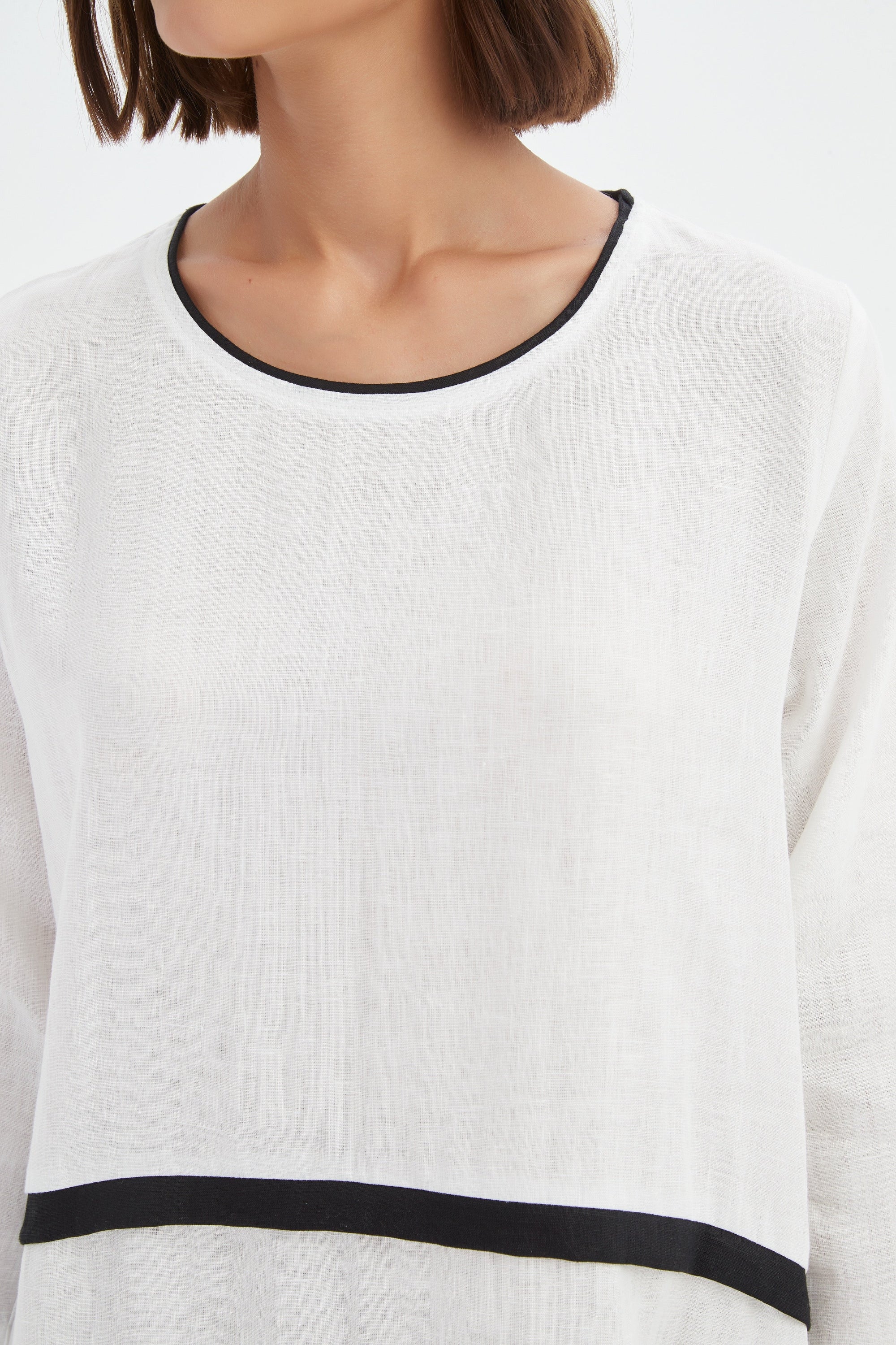 cream midi dress with black contrast worn by model 