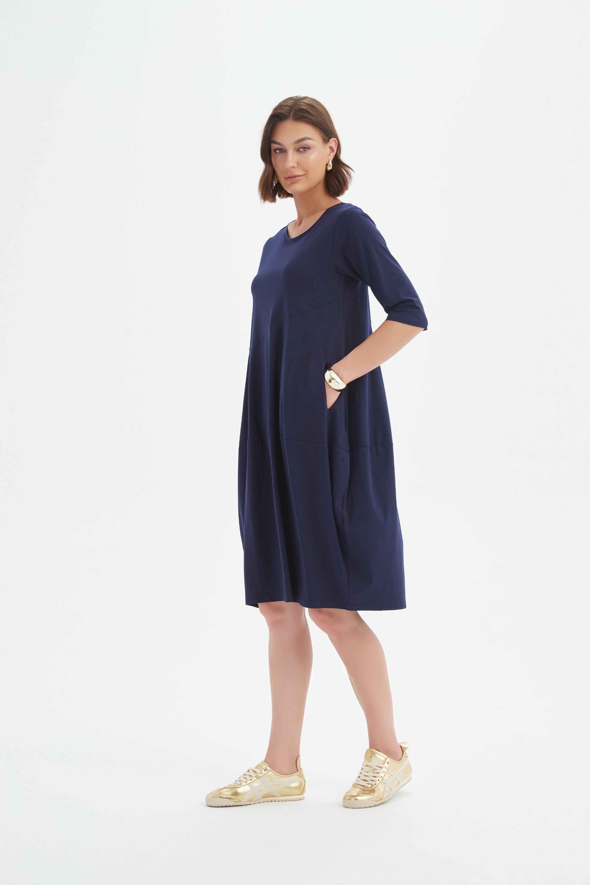 midi diagonal seam dress in navy worn by model