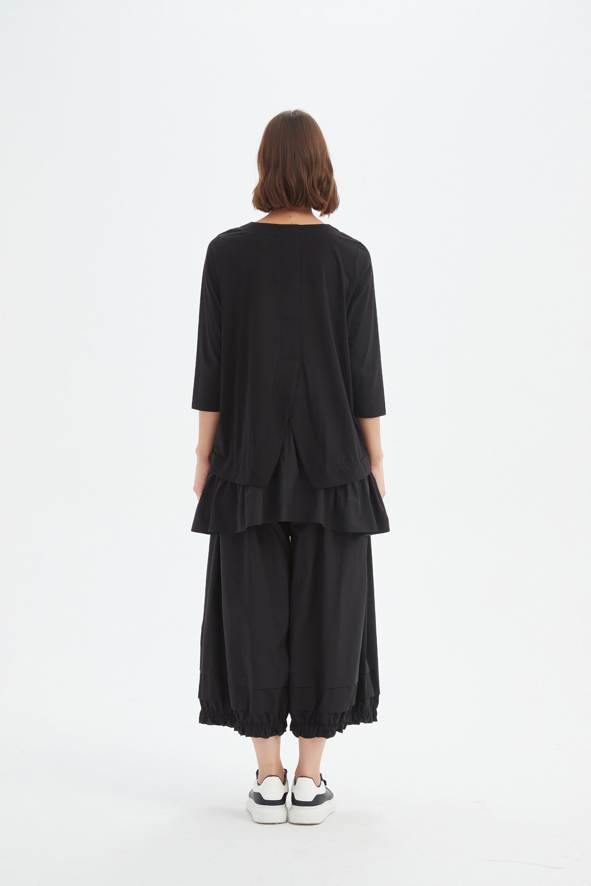 black combi top and skirt worn by model back