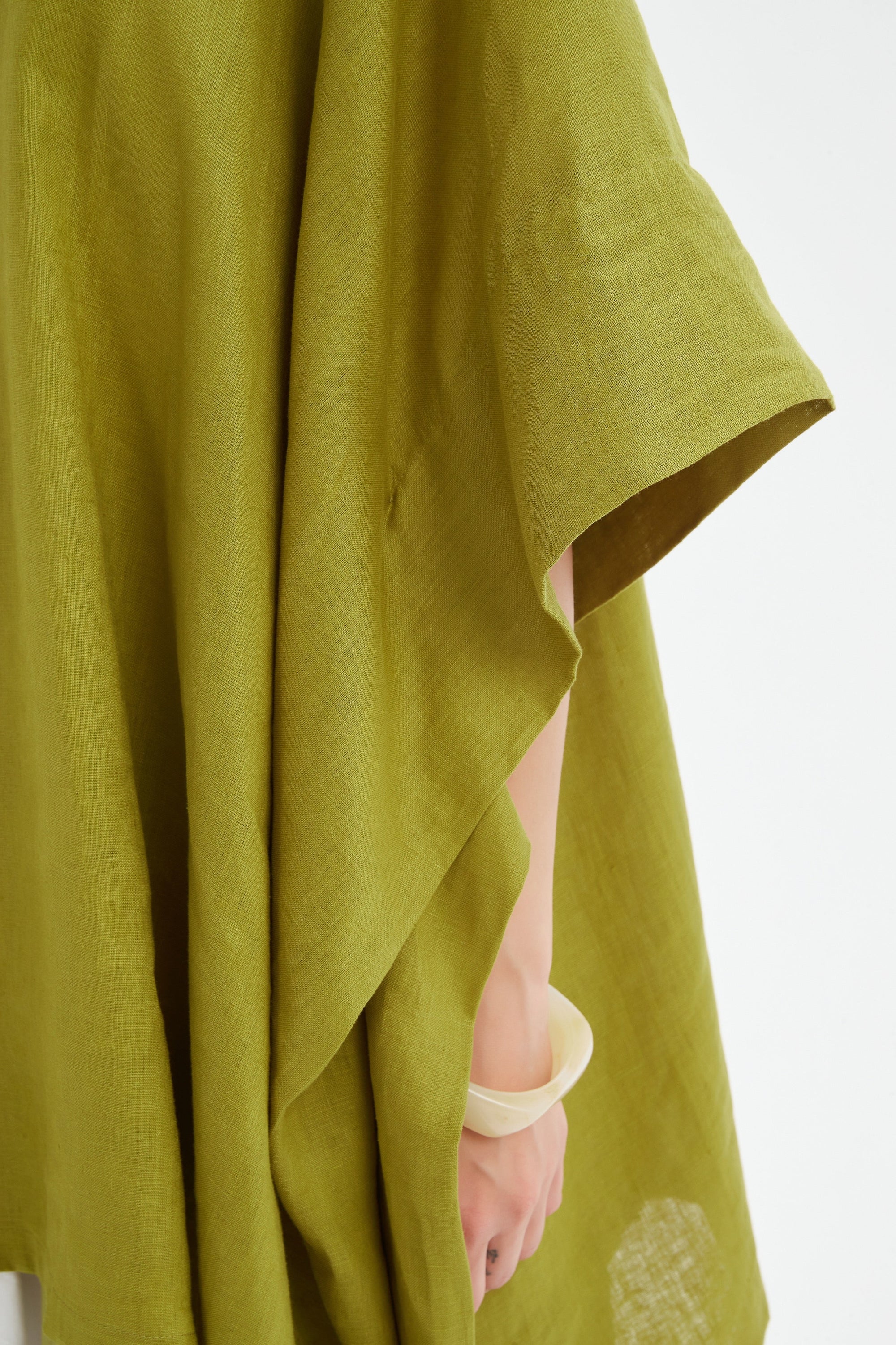 flowy waterfall poncho in chartreuse worn by model close up