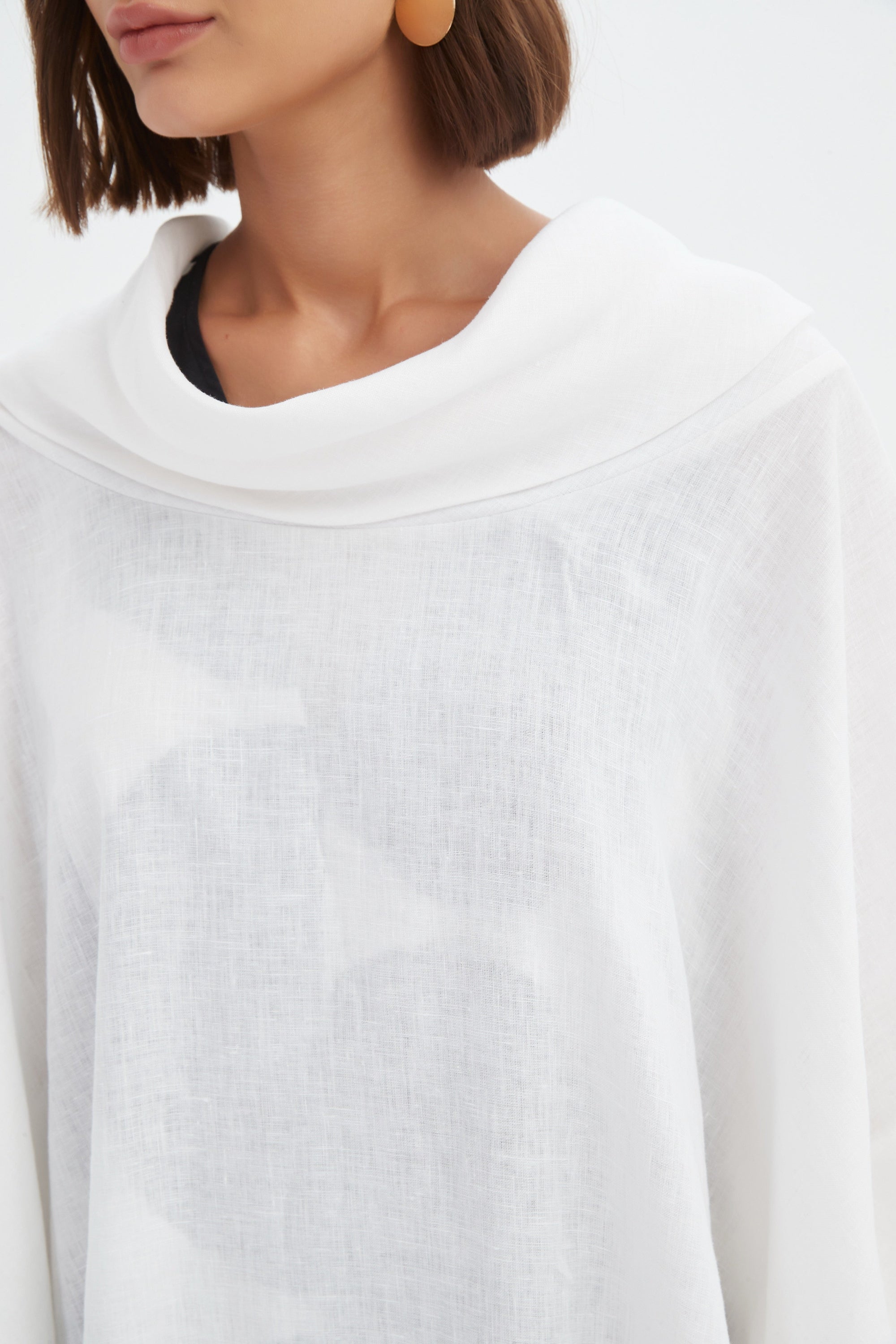 flowy waterfall poncho in white worn by model close up
