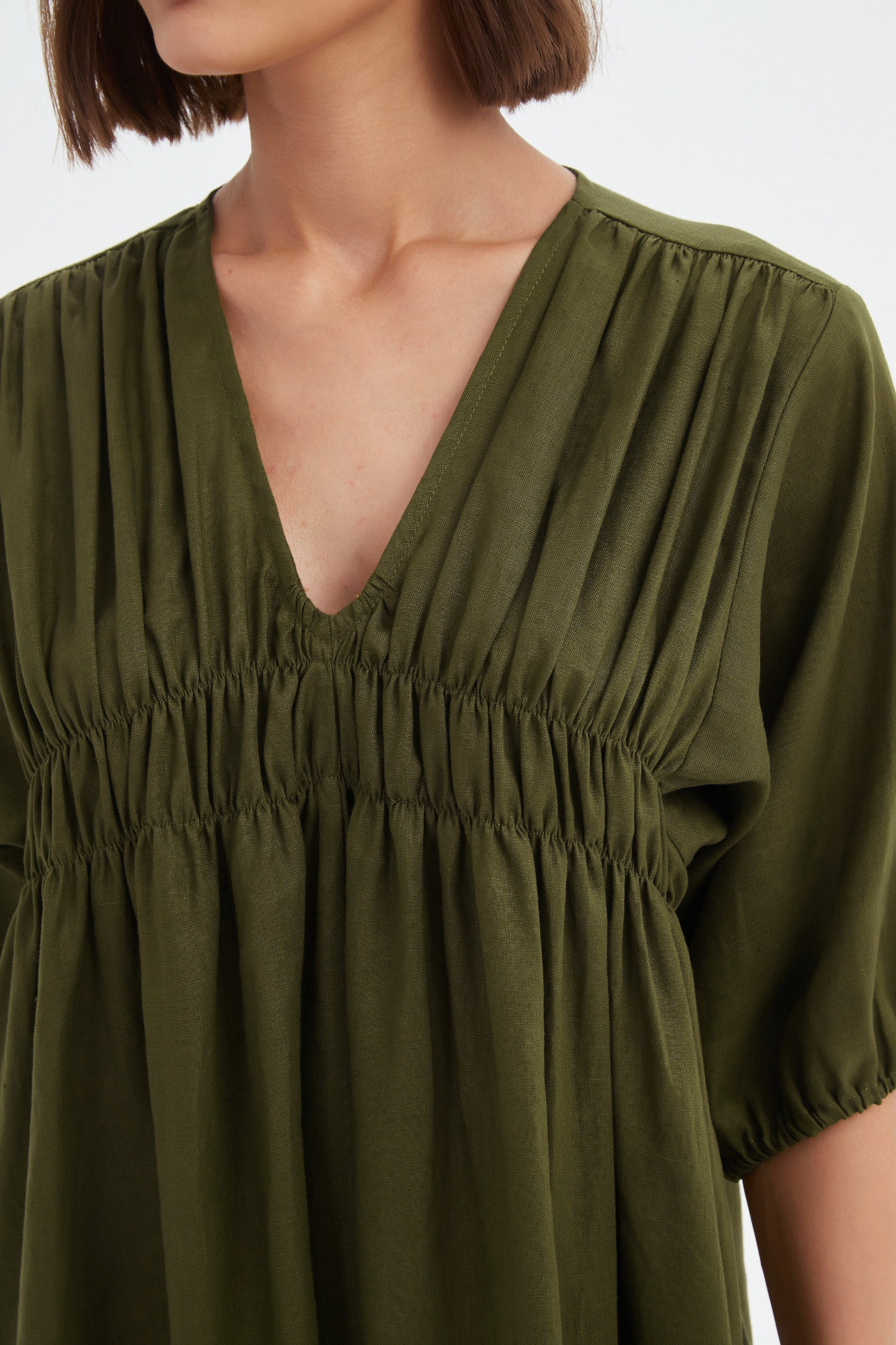 dark moss green midi dress worn by model detail