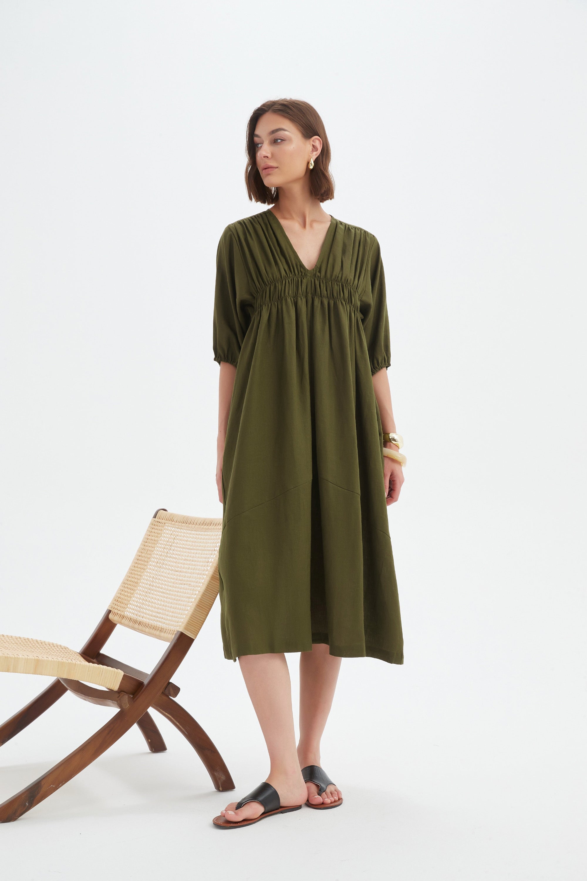 dark moss green midi dress worn by model 