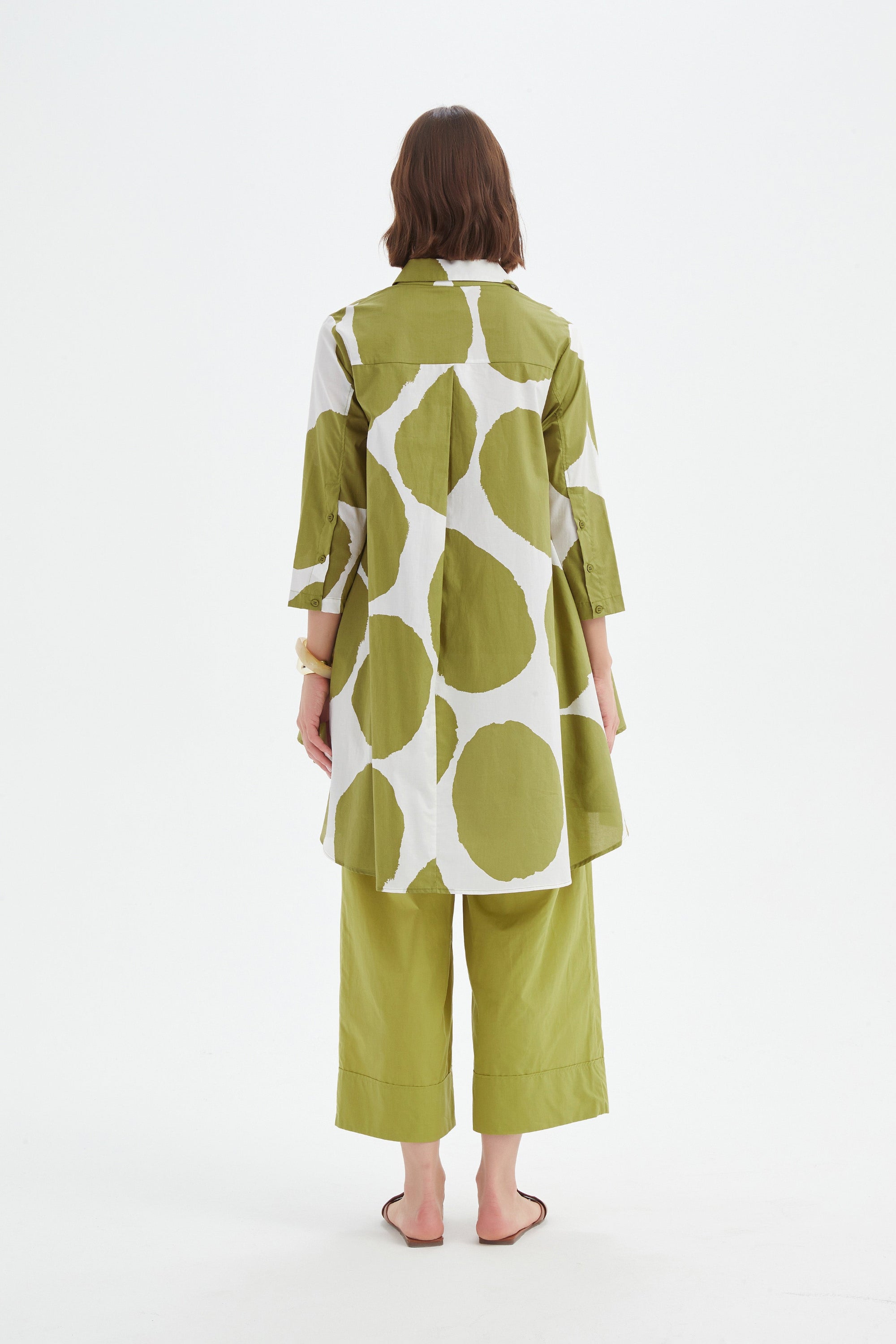 green and white spot longline shirt and green pant worn by model back