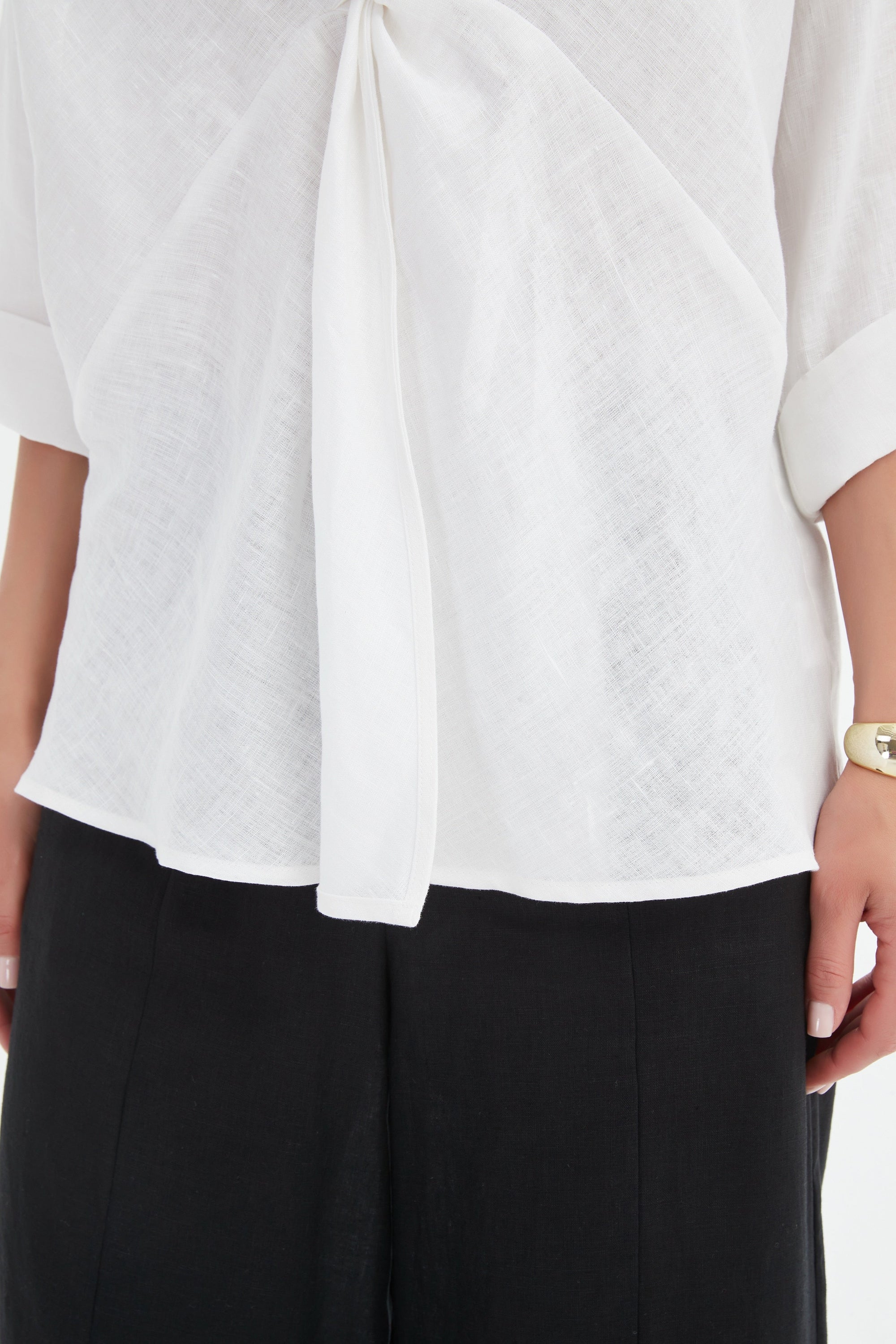 v neck twist front white blouse and black pants worn by model close up