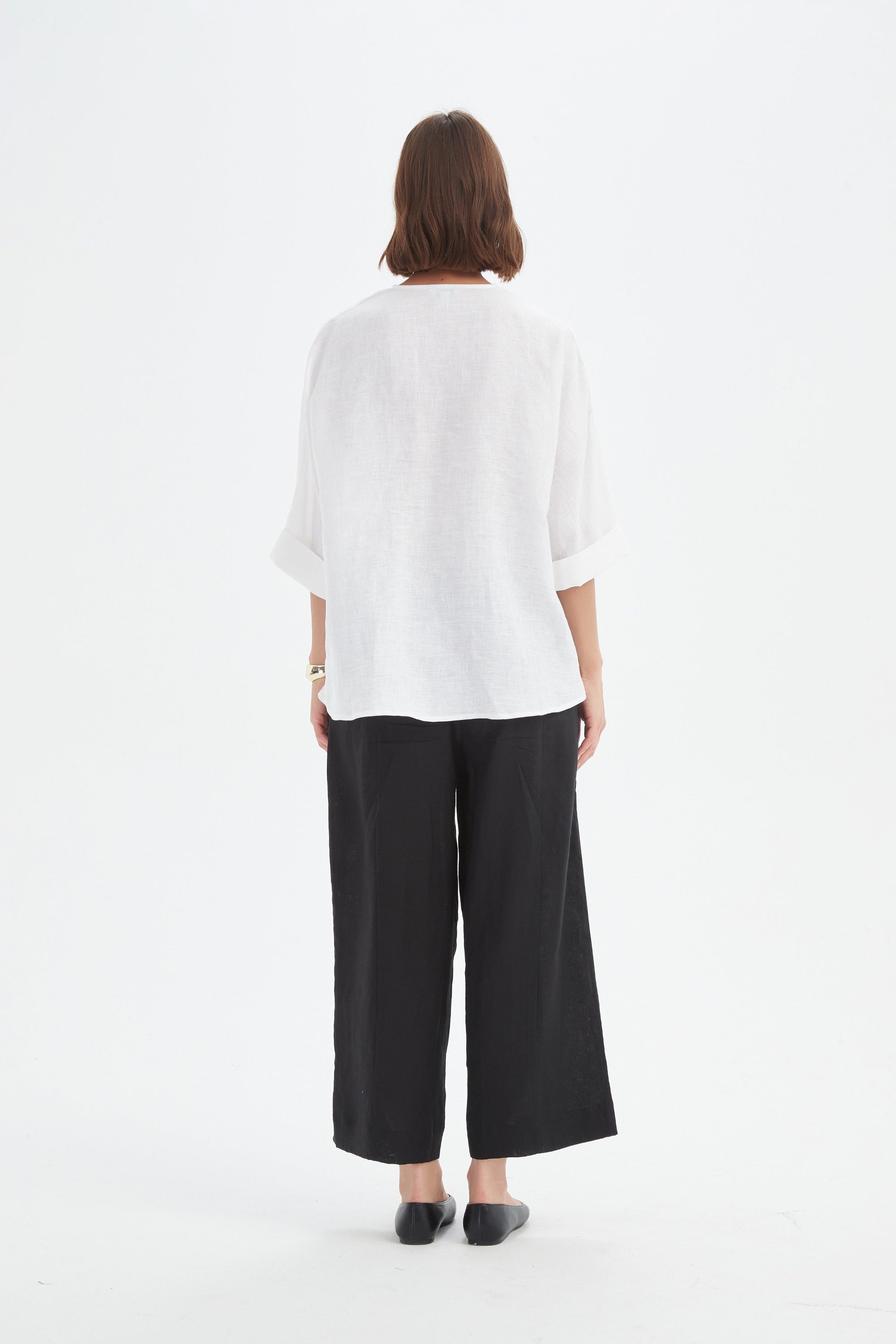v neck twist front white blouse and black pants worn by model back view