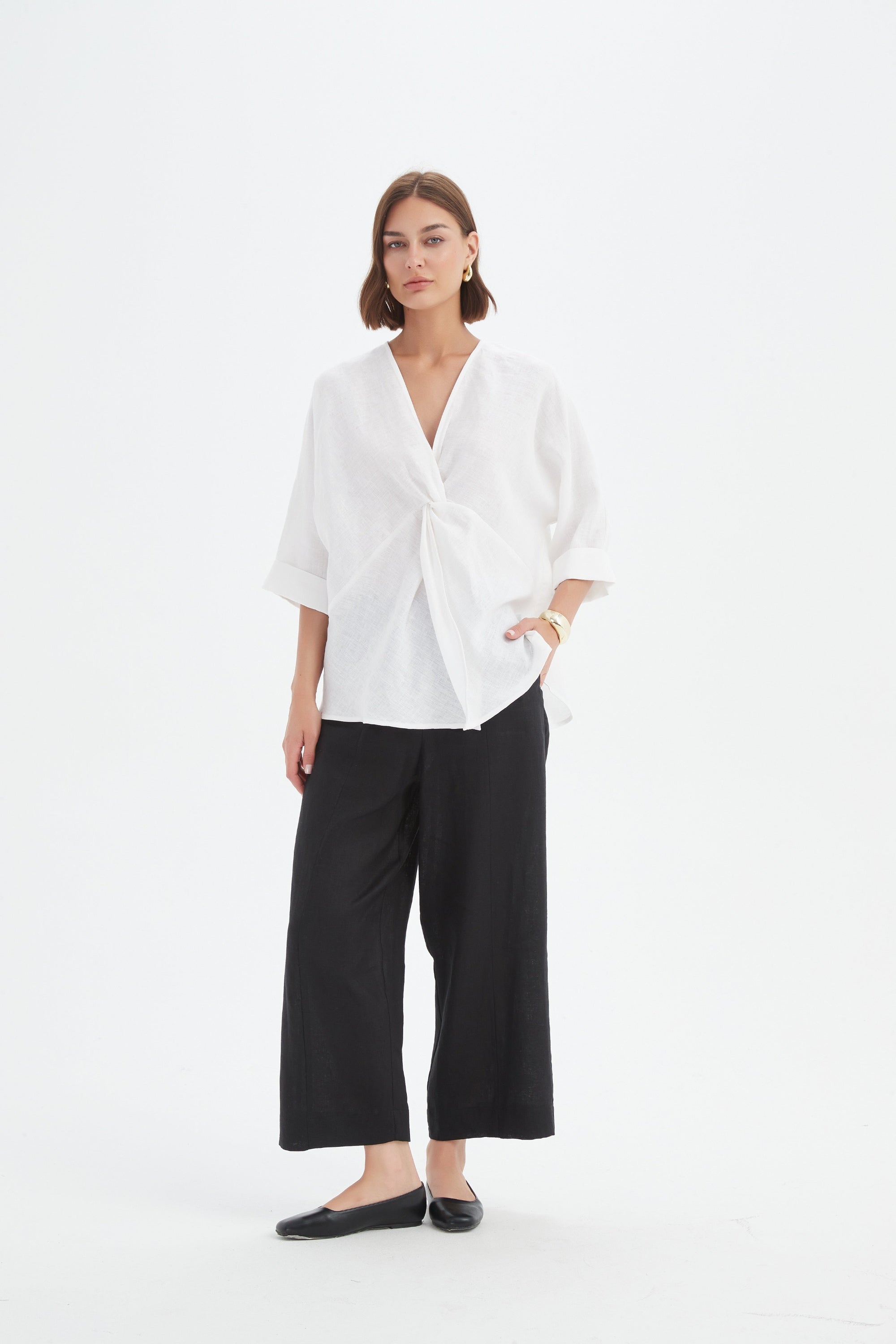 v neck twist front white blouse and black pants worn by model 