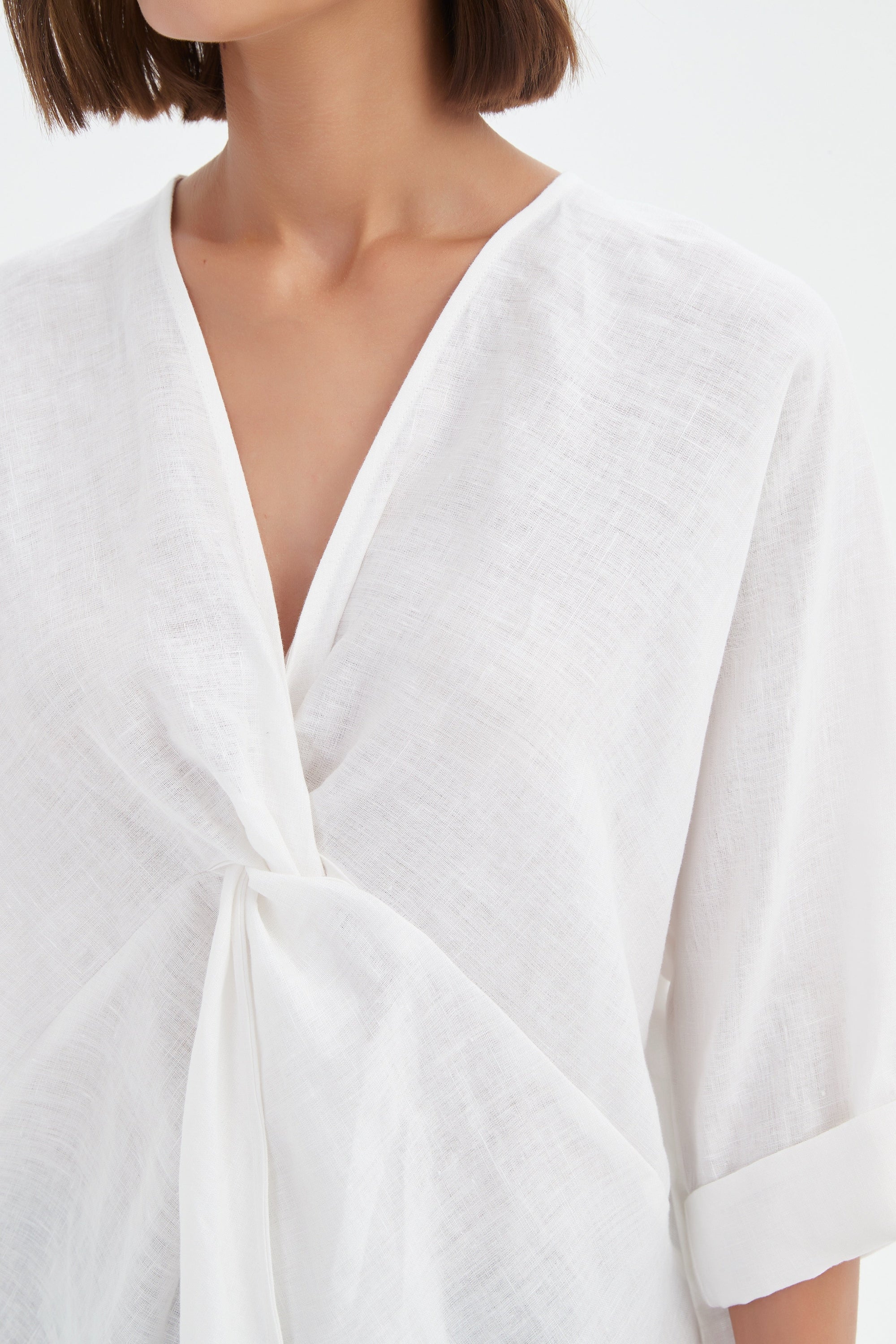 v neck twist front white blouse and black pants worn by model close up